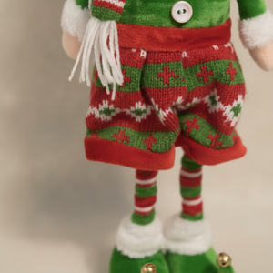 Detalle tela tejido nórdico falda duende navideño cascabeles dorados