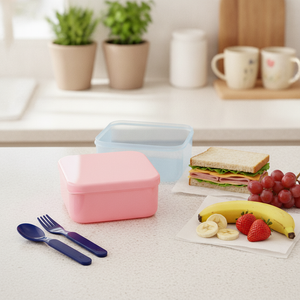 Madre preparando tupper escolar Kido rosado con colación para niño